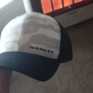 Grey camo fitted Oakley trucker style cap.